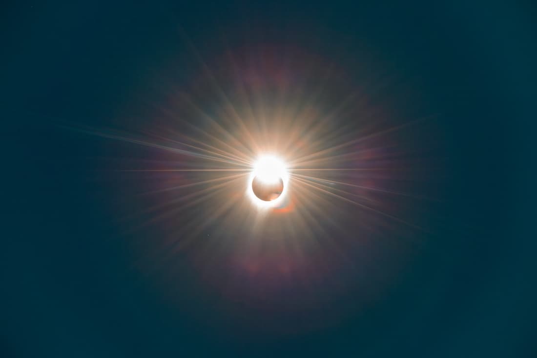 A total solar eclipse in progress as the sun begins to dissappear behind the moon