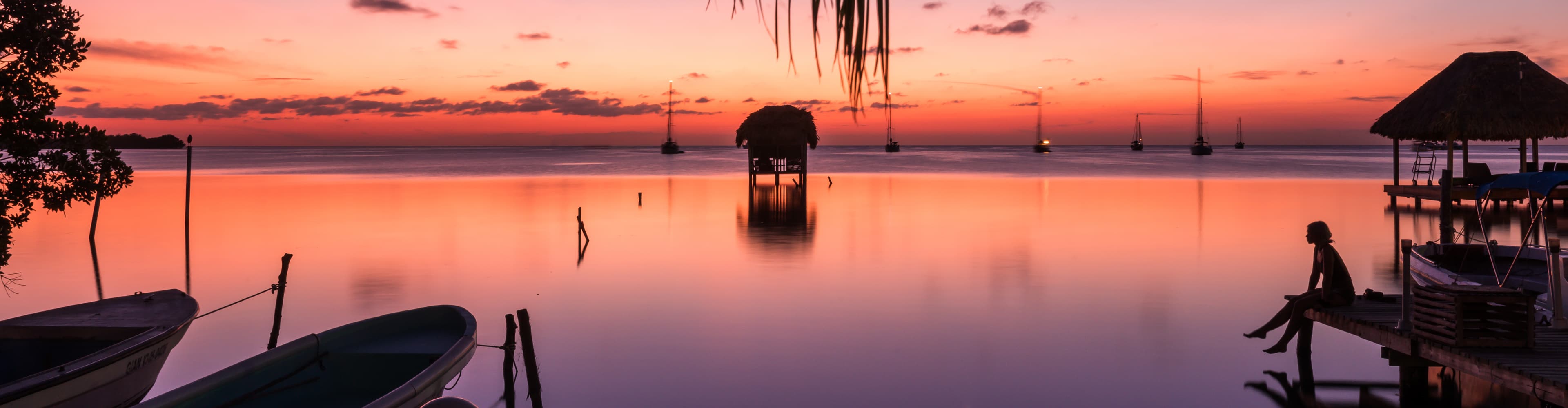 Traveller enjoying the sunset, Caye Caulker, Belize