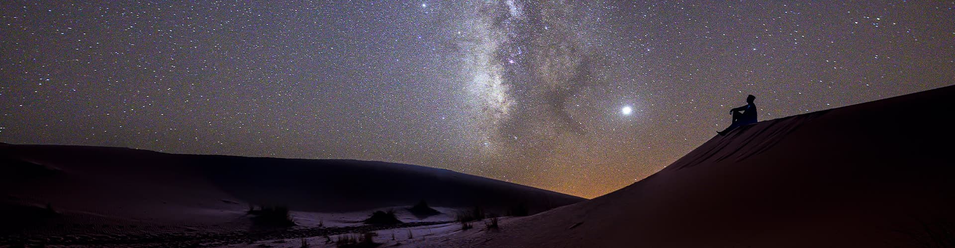 Traveller enjoying the Milky Way in the Sahara, Morocco