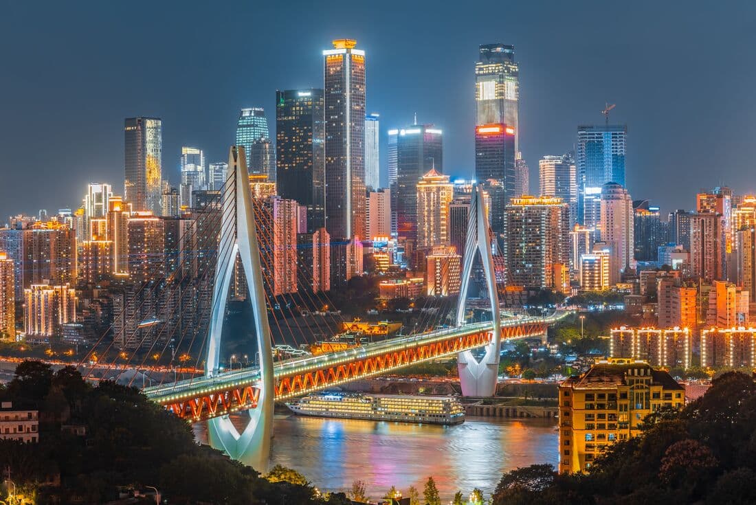 Choingqinng the Cyberpunk cityscape with bright light buildings and a sweeping bridge