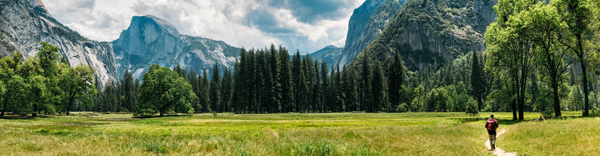 A hiker walking through Yosemite Valley, California, USA