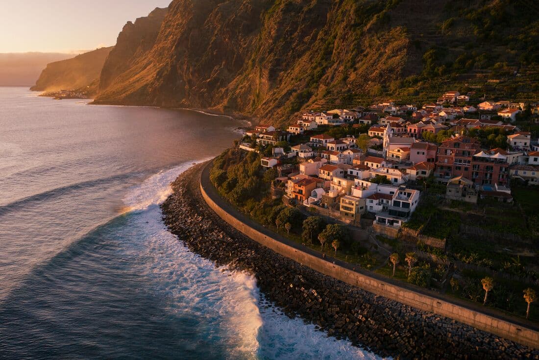 Aerial view of white buildings of a Jardim do Mar village at sunset on the coast of Madeira