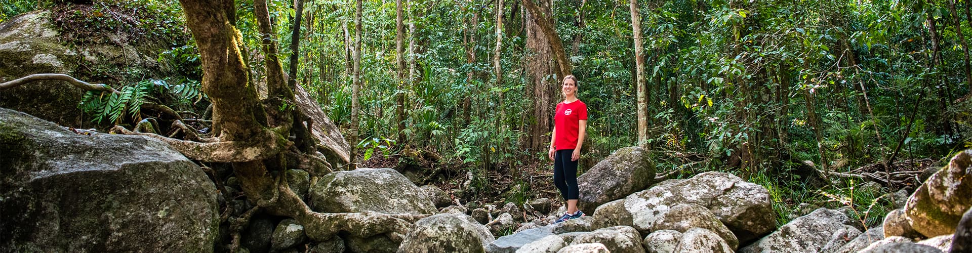 Intrepid leader standing amidst the stones of the Daintree Rainforest