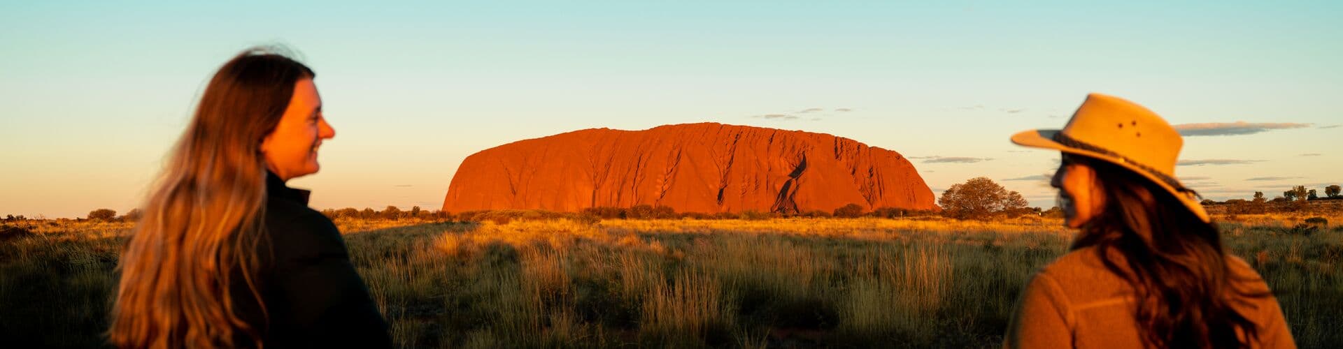 Travellers enjoy view of Uluru sunset