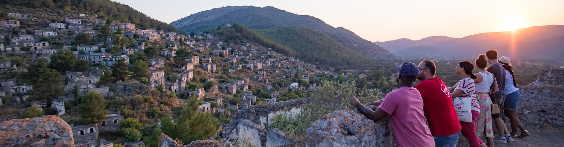 Group of travellers watching sunset in Kayakoy village, Turkey