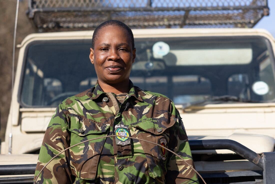 Black Mamba member poses for photo in front of jeep, Botswana, South Africa