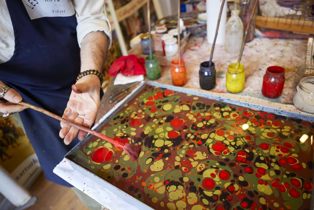 Ebru water marbling master demonstrates his craft in his workshop in Istanbul, Turkey