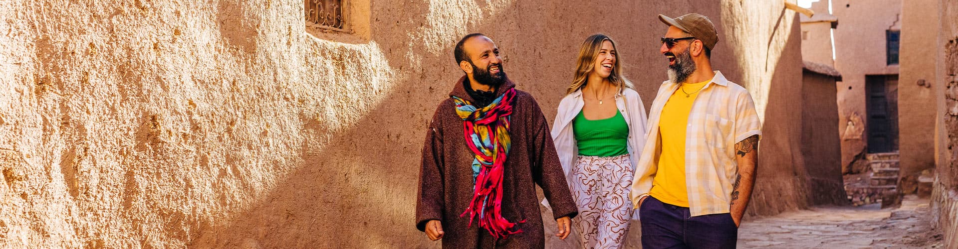 Travellers exploring Ait Benhaddou with local leader in Morocco