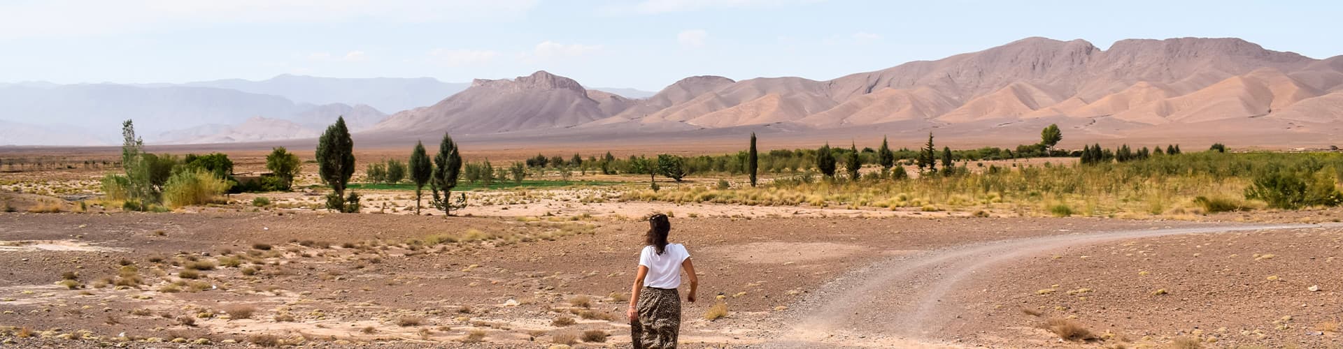 Female traveller walking towards the Atlas Mountains in Morocco