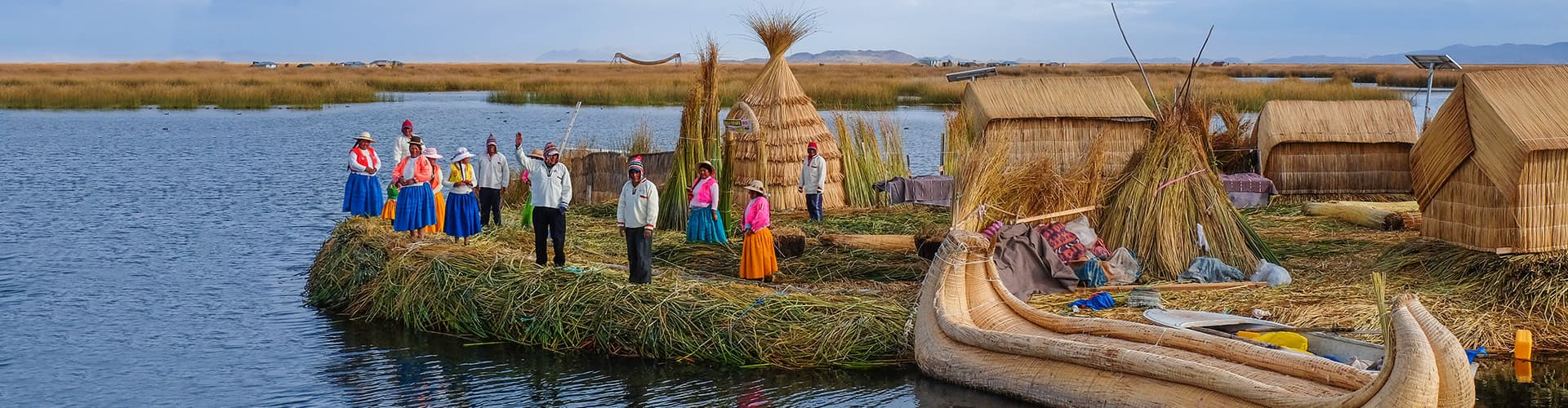 Local villagers wave welcome on floating islands, Lake Titicaca, Peru
