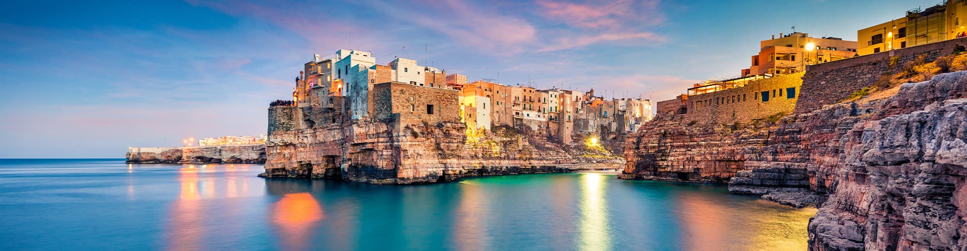 Panoramic evening cityscape of Polignano a Mare town, Puglia region, Italy, Europe.