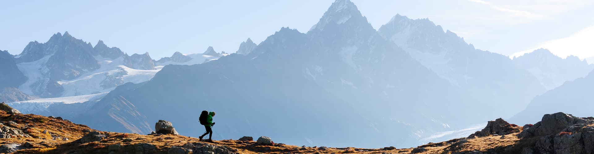 Hiker trekking with Mont Blanc mountain range in the background