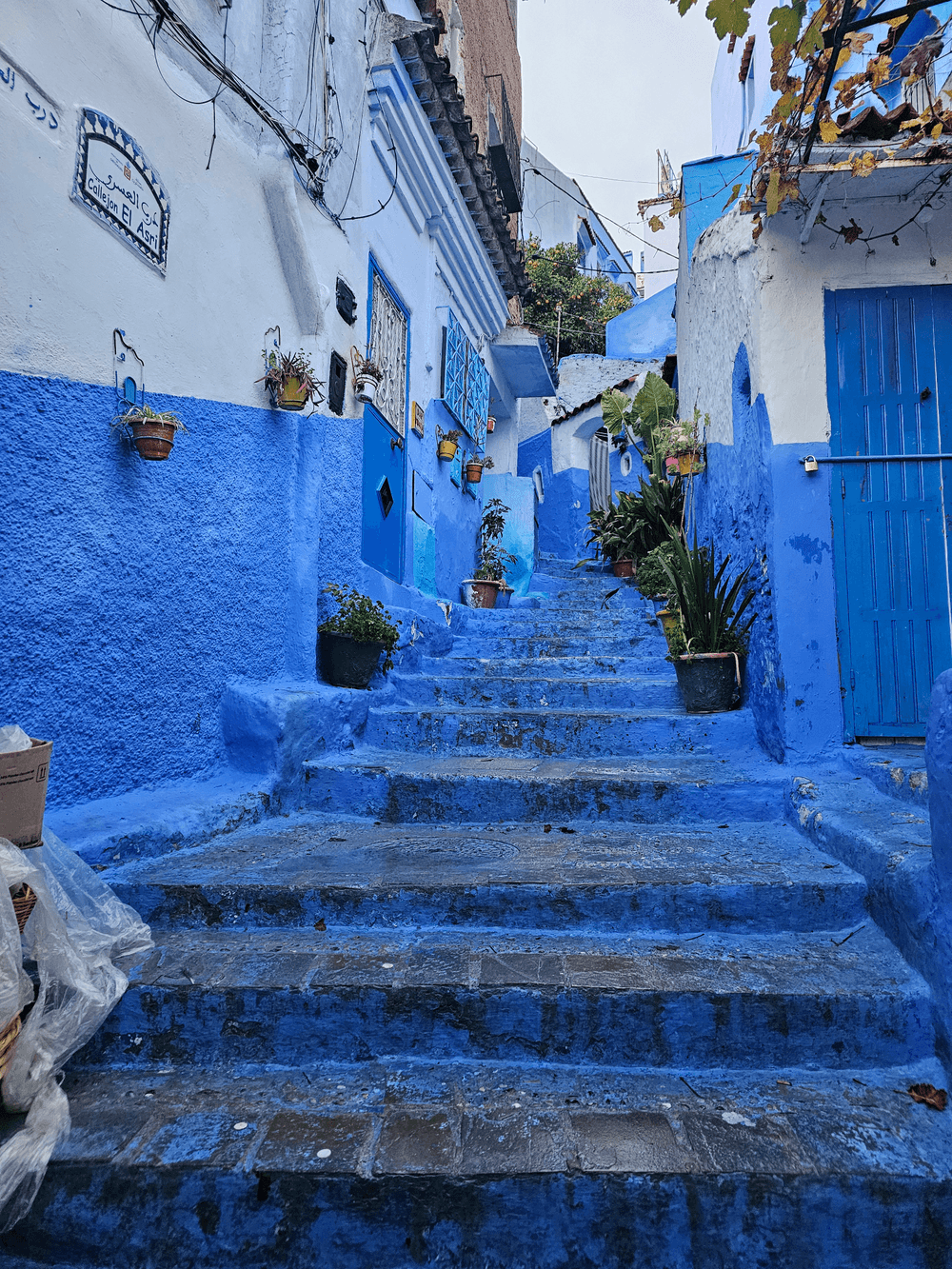 Blue steps between painted buildings in Chefchaouen.